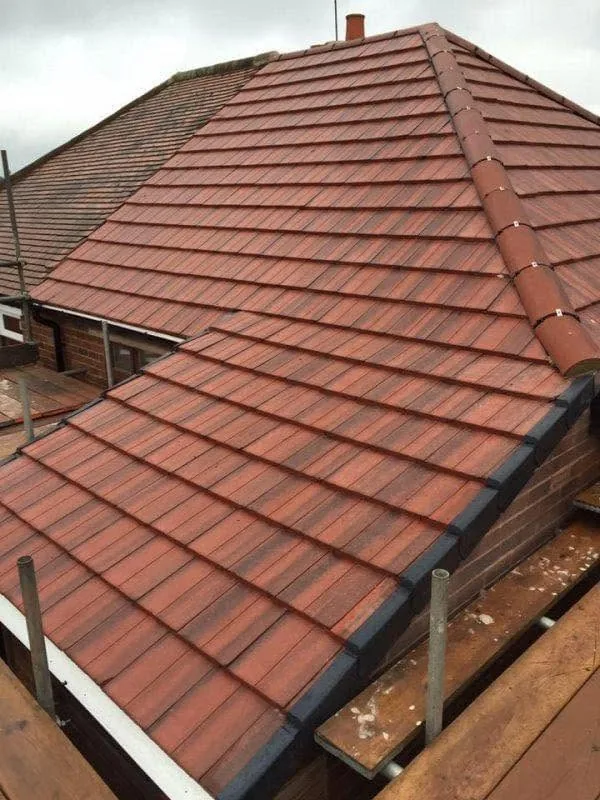 Red tiled domestic roof during roofing work